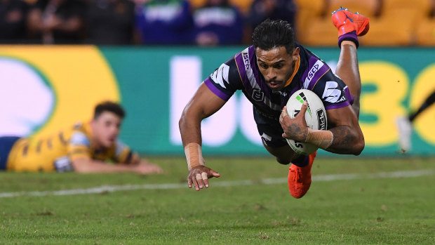 Josh Addo-Carr scores one of his two tries in Melbourne's demolition of Parramatta on Saturday.