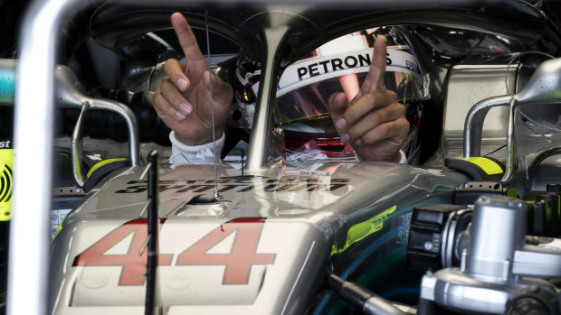 Friendly circuit: Mercedes driver Lewis Hamilton gestures for his monitor during the first practice session.