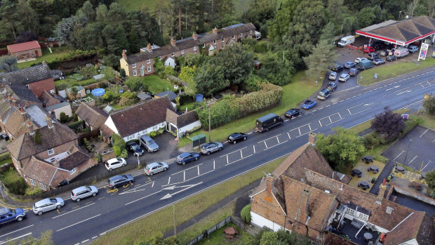 Short-term pain: motorists queue for fuel at a petrol station in Ashford, England.