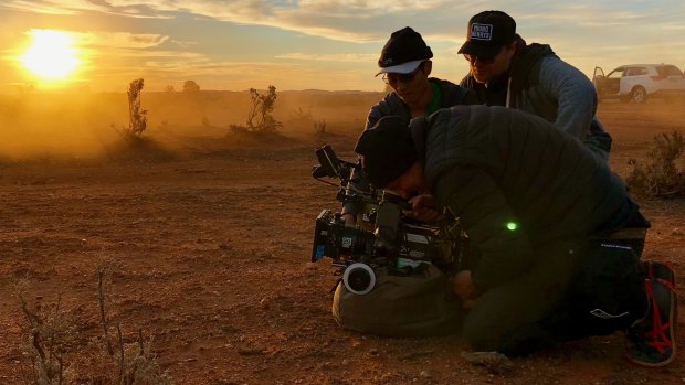"The whole community actually loves movies": director Heath Davis (rear) with director of photography Chris Bland and focus puller Jeffrey Truong on the set of the film Locusts at Broken Hill.
