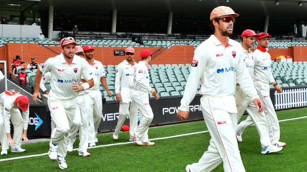 Travis Head leads his team onto the field at Adelaide Oval, where he scored a century against the Blues.