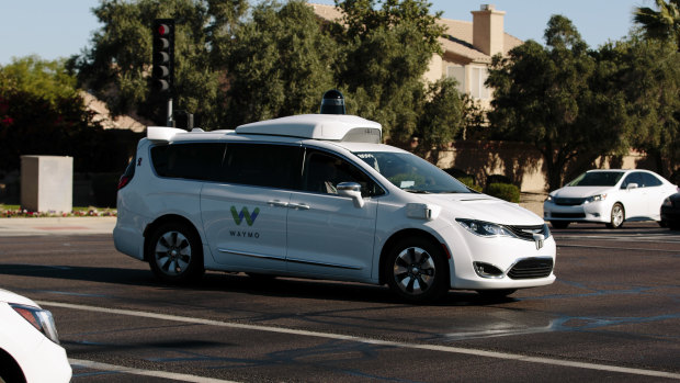 A Waymo autonomous vehicle passes through an intersection in Chandler, Arizona.