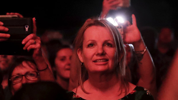 Environment Minister Sussan Ley watches from the crowd as Peter Garrett from Midnight Oil performed at the celebrations.