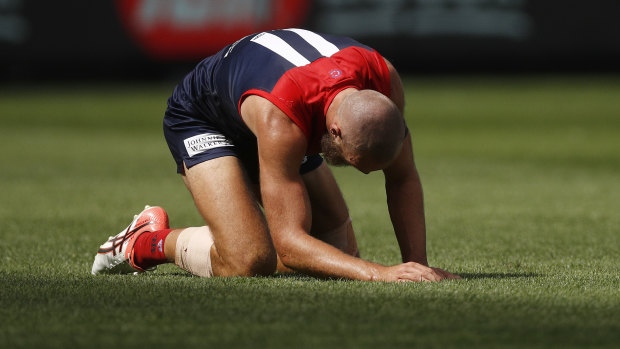 Gawn gathers himself after some physical attention at the MCG.