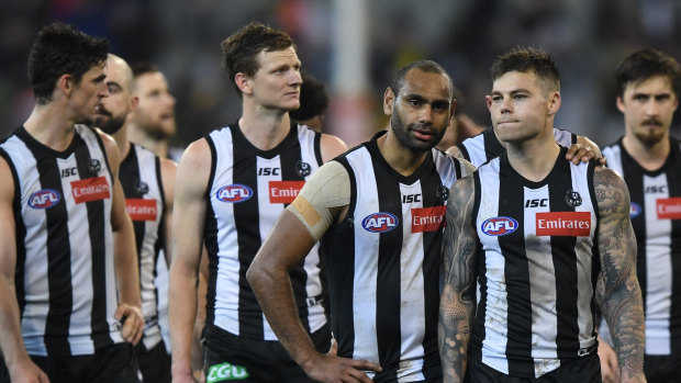 Pie fright: Collingwood players walk off after Friday night's loss to Richmond.