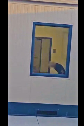 An image from video footage showing the Canadian woman in her room, before the window was blacked out by guards. 