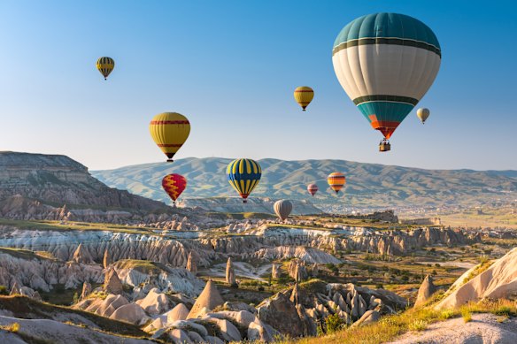 Hot-air balloons aloft the skies above Cappadocia, Turkey.