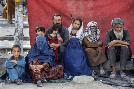 A family from the Balkh province sits in a camp in Kabul for people displaced from rural areas by the advance of the Taliban. Less than three weeks later, the Taliban would have control of the capital.