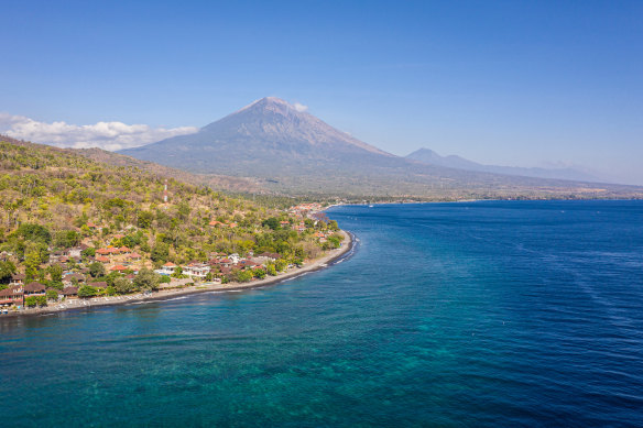 The shadow of Mount Agung looms over Amed.