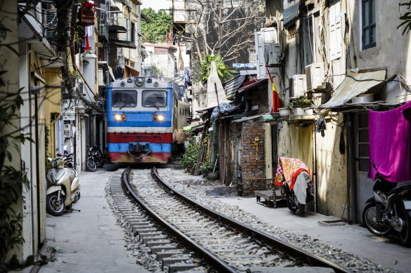 The Lotus Express passes through the astonishingly narrow Train Street.
