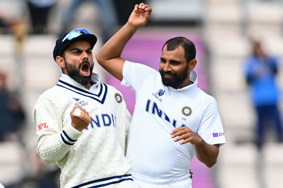 Virat Kohli and Mohammed Shami celebrate the wicket of Colin de Grandhomme.
