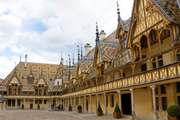 Burgundy’s Hospices de Beaune with its distinctive courtyard and glazed terracotta roofs.