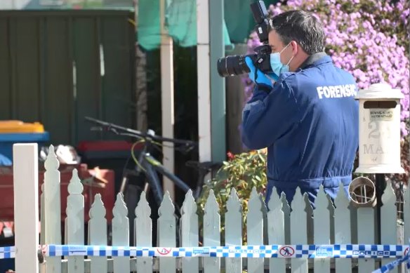 A forensic officer photographs the scene of Emma Bates’ death in Cobram.