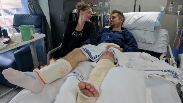 Mr Hetherington, pictured with his partner Lyndal, was hospitalised for three weeks but requires further surgery on his leg.
