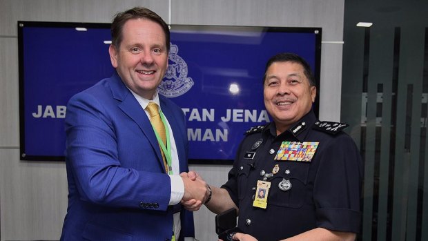 Senior AFP liaison officer Jason Byrnes with Wan Ahmad Najmuddin bin Mohd in 2017.