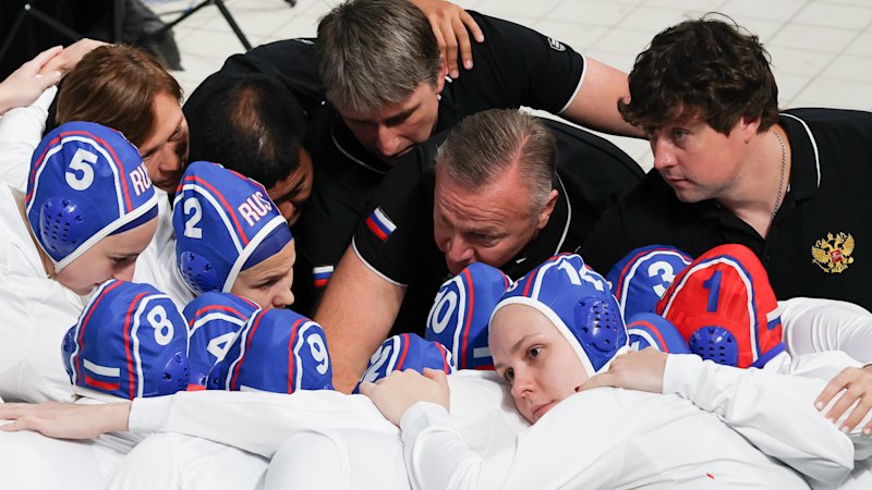 ‘Happy to see our flag’: Russian athletes return to the pool as protesters slam government