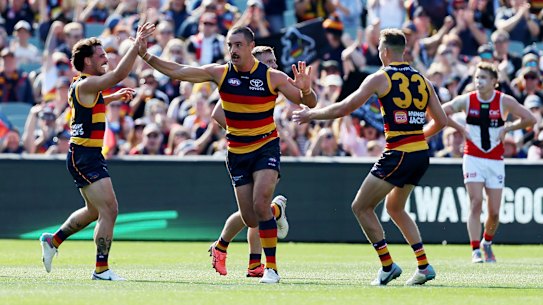 Taylor Walker celebrates one of his five goals in the win.