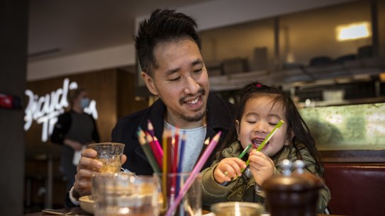Christopher Ong and daughter Ava, 3, enjoy a sit in coffee at High Street cafe Bicycle Thieves as Melbourne emerges from its latest lockdown.