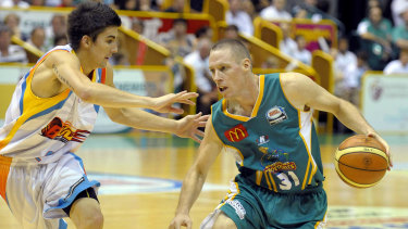 John Rillie, right, in action for the Townsville Crocodiles during his playing days. 