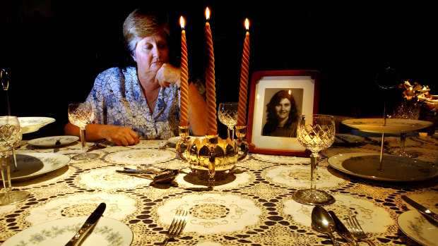 Trish Riggs' mother Carol Saxton at home in Queanbeyan in 2003. Her daughter made the tablecloth and Mrs Saxton always laid it out at Christmas. Mrs Saxton died in 2011, not knowing what happened to her daughter.