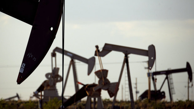 Pumpjacks work in an oil field in the US.