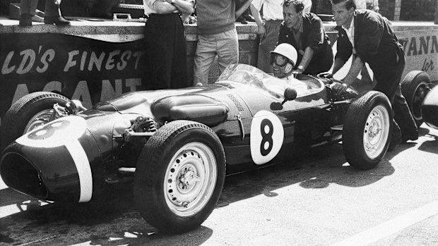 Stirling Moss, at the wheel of the revolutionary new Ferguson racing car in 1961, gets a shove off from mechanics as he takes practice laps at Silverstone, England. 