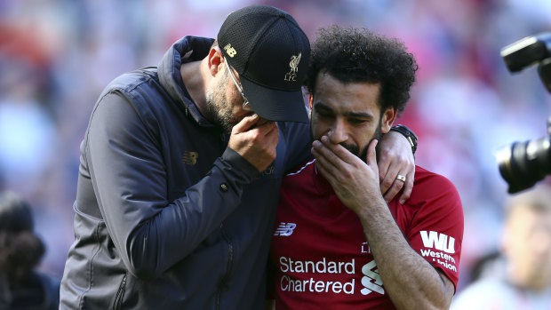 Liverpool manager Juergen Klopp talks to Mo Salah at the end of the Wolves game, and the season.