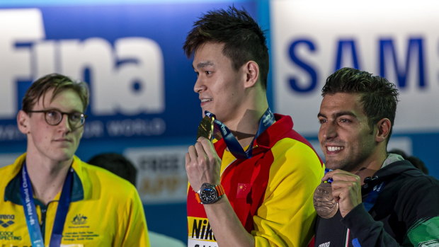 Mack Horton (left) made his point against Sun Yang (centre) but says the focus should shift to racing for the time being.