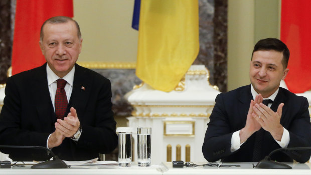 Ukrainian President Volodymyr Zelensky, right, and Turkey's President Recep Tayyip Erdogan applaud during a signing ceremony in Kiev, Ukraine. 