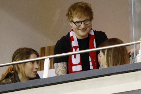Musician Ed Sheeran watches on from a corporate box. 