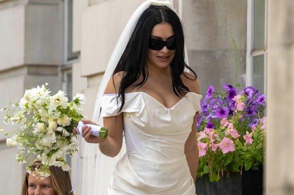 Charli XCX dials down the lace in a Vivienne Westwood minidress at her July 2025 wedding.