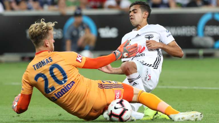 Victory keeper Lawrence Thomas stops the attack by Sarpreet Singh.