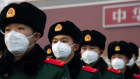 Chinese police officers outside the Tianenmen gate in Beijing: the Chinese people have traded obedience for protection by the state - the epidemic now threatens to change some of that thinking.