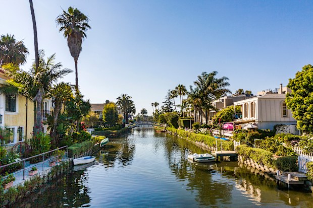 A canal lined with houses, trees and plants in Los Angeles
