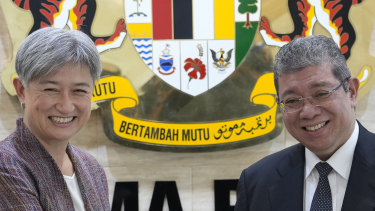 Malaysian Foreign Minister Saifuddin Abdullah, right, greets his Australian counterpart  Penny Wong at Foreign Ministry in Putrajaya, Malaysia.