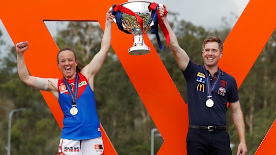 IPSWICH, AUSTRALIA - NOVEMBER 27: Daisy Pearce of the Demons and Mick Stinear, Senior Coach of the Demons lift up the premiership cup during the 2022 AFLW Season 7 Grand Final match between the Brisbane Lions and the Melbourne Demons at Brighton Homes Arena, Springfield, Ipswich on November 27, 2022 in Ipswich, Australia. (Photo by Dylan Burns/AFL Photos via Getty Images)