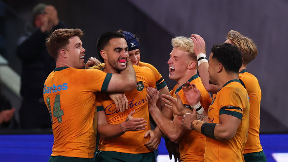 Tom Wright celebrates after scoring against Wales.