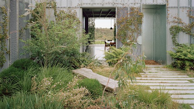 A climber-covered trellis screens Hedge House itself from its garden