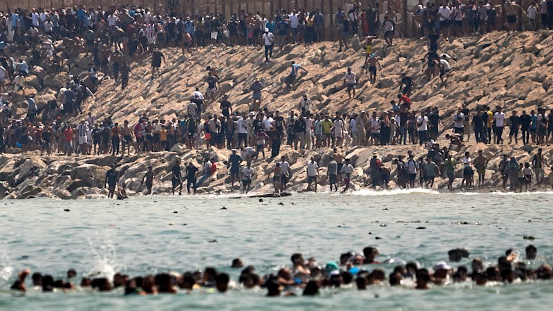 ‘Absolute chaos’: Thousands of people rush across Moroccan border, hoping to get to Europe