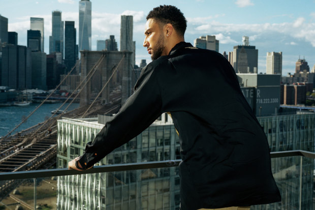 Simmons on the balcony of his new eight-bedroom apartment in Brooklyn. 