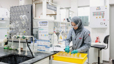 A worker at Lynas Corp, a rare earths company, doing lab tests.