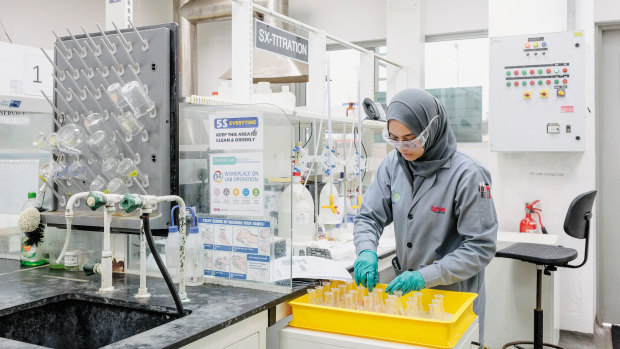 A worker at Lynas Corp, a rare earths company, doing lab tests.