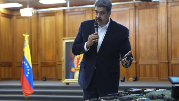 President Nicolas Maduro displays military communications equipment he said was seized during an incursion into Venezuela in May. Maduro maintains the US is trying to overthrow him.