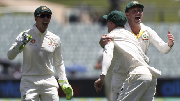 Shrewd management: Peter Handscomb, centre, is congratulated by Shaun Marsh and Tim Paine after taking a catch to dismiss Ajinkya Rahane off the bowling of Josh Hazlewood.