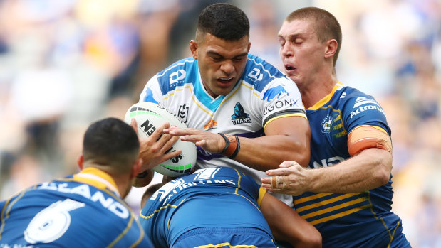 Three Eels defenders try to stop a charge from Gold Coast wrecking ball David Fifita.