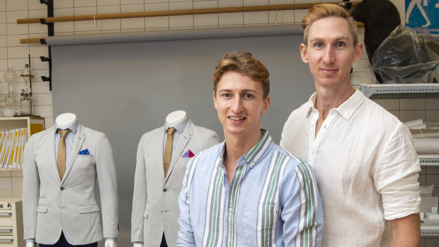 Craig Burns (right) and Luke Sullivan with their wedding suits which they are donating to the Queensland Museum's social history collection.