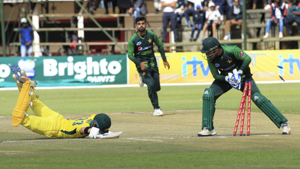 Close call: D'Arcy Short dives to avoid a run out at the Harare Sports Club.