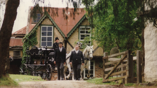 Clifton Pugh's body is taken to the funeral service in a horse-drawn hearse.