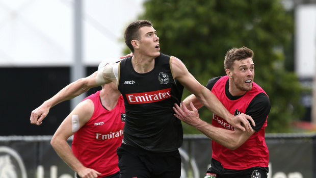 Jordan Roughead jostles with Mason Cox at training earlier this week.