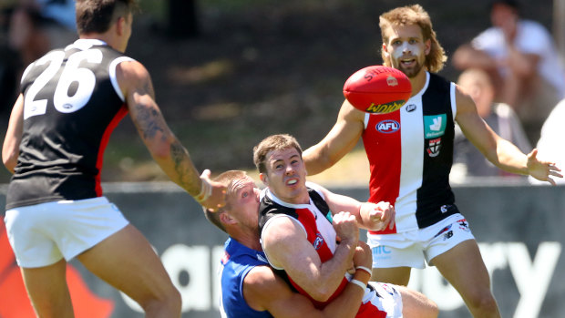 Jack Higgins fires off a handball for the Saints.